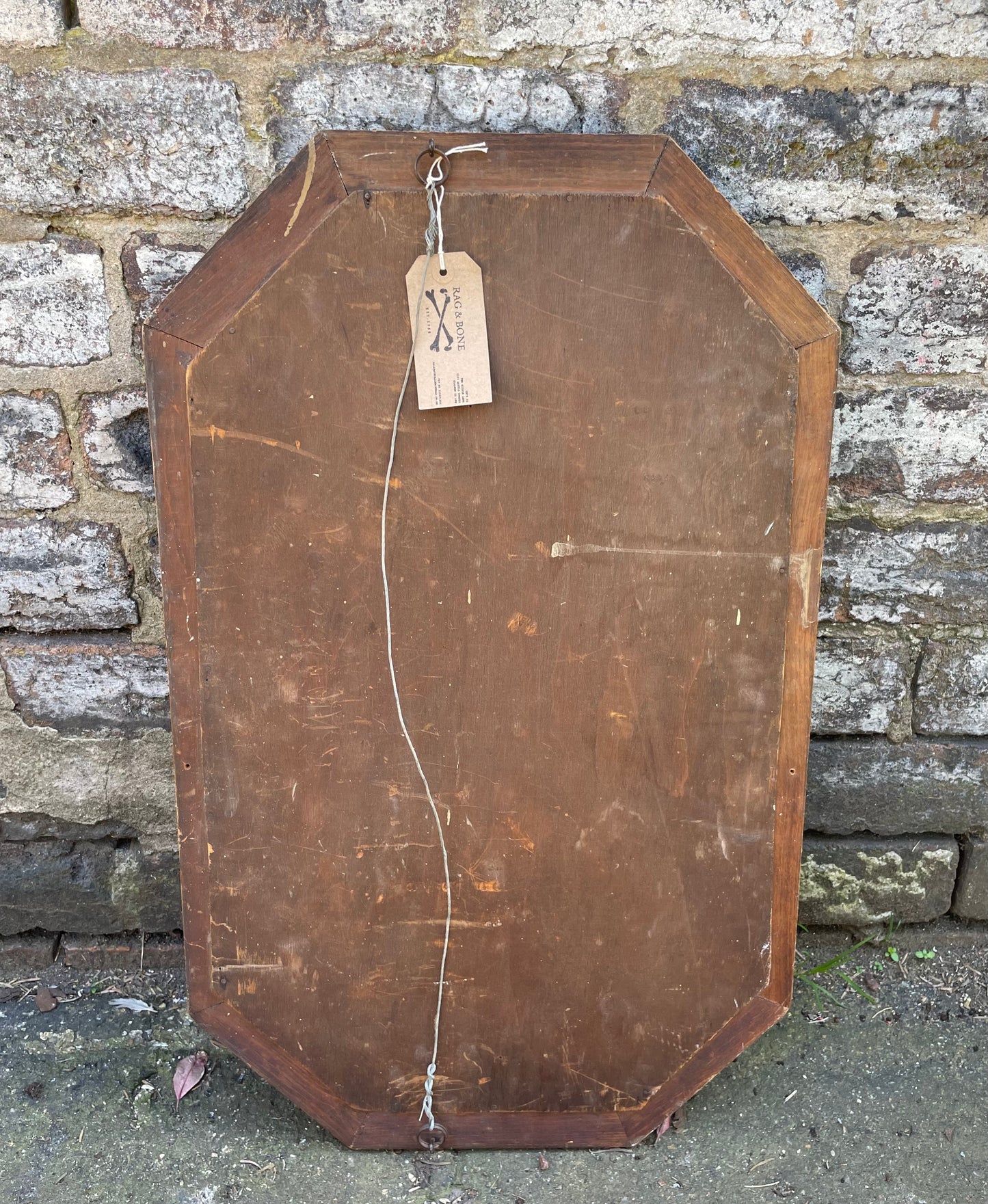 Antique carved octagonal mirror with embossed wooden frame, bevelled glass